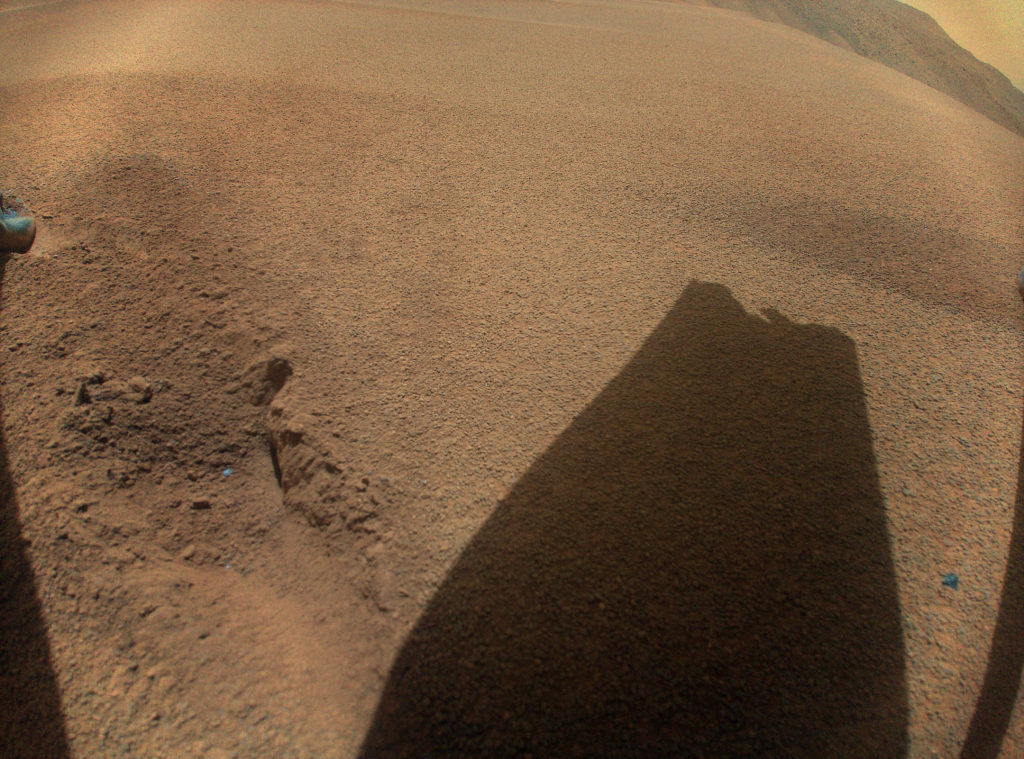 After its 72nd flight on Jan. 18, 2024, NASAs Ingenuity Mars Helicopter captured this color image showing the shadow of one of its rotor blades, which was damaged during touchdown