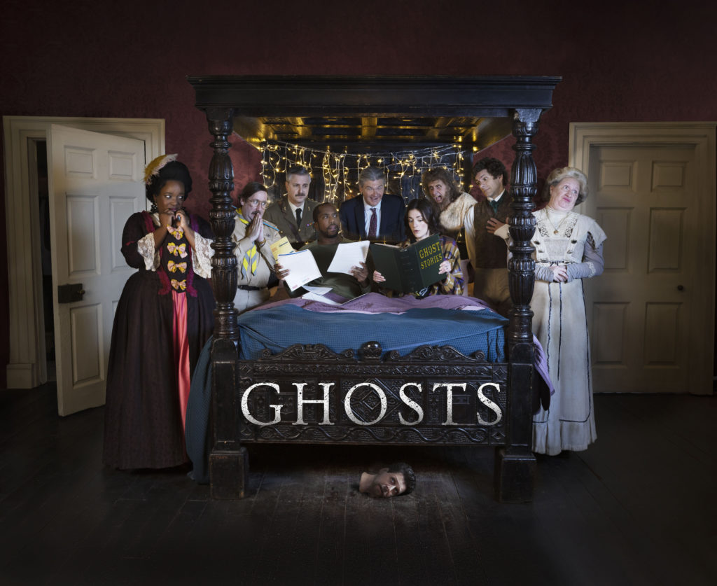 Kitty (LOLLY ADEFOPE), Pat (JIM HOWICK), The Captain (BEN WILLBOND), Mike (KIELL SMITH-BYNOE), Julian (SIMON FARNABY), Alison (CHARLOTTE RITCHIE), Robin (LARRY RICKARD), Thomas Thorne (MAT BAYNTON), Lady Button (MARTHA HOWE-DOUGLAS) in key art for Ghosts series 5