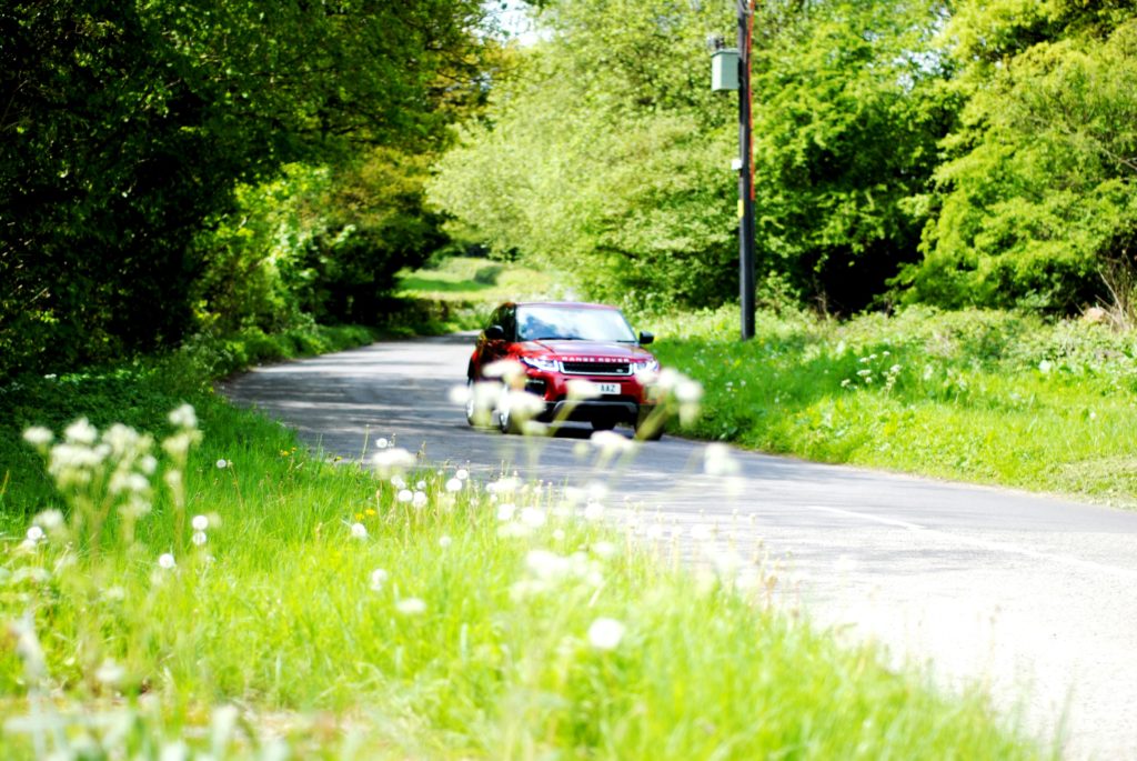 A car driving down a country lane