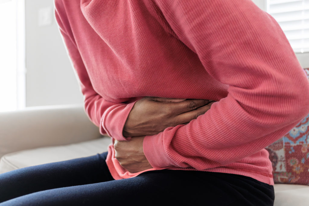 Woman Holds Her Abdomen in Pain