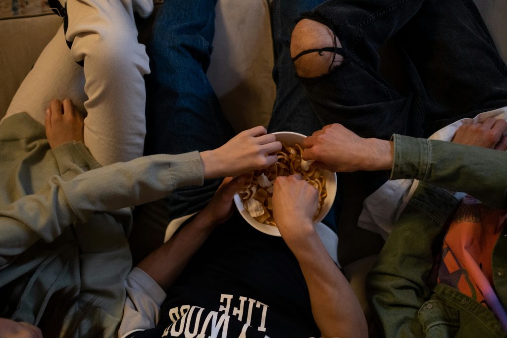People sharing a bowl of snacks