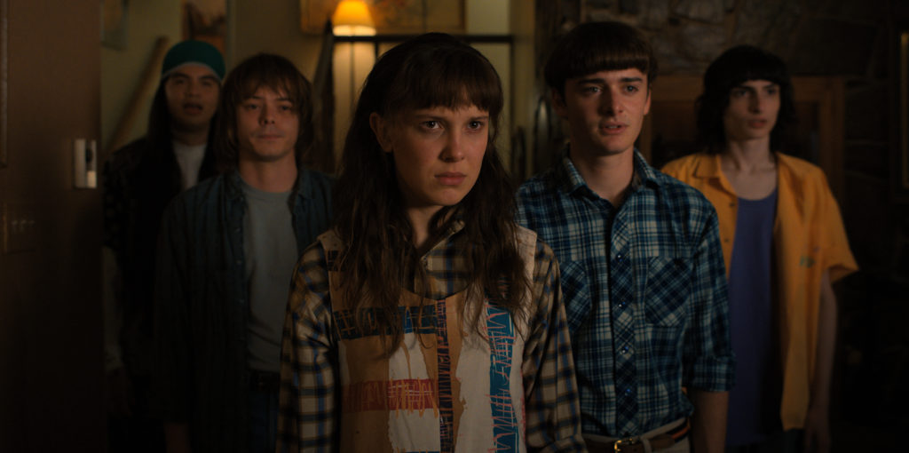 Eduardo Franco as Argyle, Charlie Heaton as Jonathan, Millie Bobby Brown as Eleven, Noah Schnapp as Will Byers, and Finn Wolfhard as Mike Wheeler in STRANGER THINGS